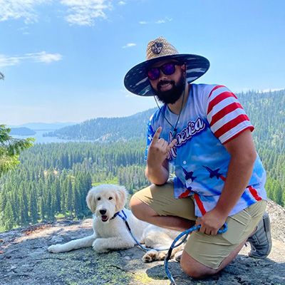 Photo of EDC Remote dart tournament admin Sklyer with his dog on a hike in the mountains